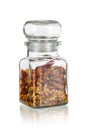 Glass jar with dried chili peppers clove isolated