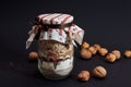 Glass jar filled with cookie baking mix, includes layers of cereal, flour, brown and white sugar and chocolate powder, covered