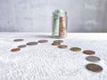 Glass Jar Filled With Euro Banknotes and Coins on Table. Concept of savings ranging from small money to large Royalty Free Stock Photo