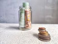 Glass Jar Filled With Euro Banknotes and Coins on Table. Concept of savings ranging from small money to large Royalty Free Stock Photo