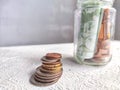 Glass Jar Filled With Euro Banknotes and Coins on Table. Concept of savings ranging from small money to large Royalty Free Stock Photo