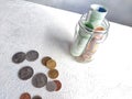 Glass Jar Filled With Euro Banknotes and Coins on Table. Concept of savings ranging from small money to large Royalty Free Stock Photo