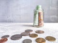 Glass Jar Filled With Euro Banknotes and Coins on Table. Concept of savings ranging from small money to large Royalty Free Stock Photo