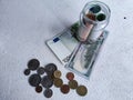 Glass Jar Filled With Euro Banknotes and Coins on Table. Concept of savings ranging from small money to large Royalty Free Stock Photo