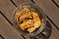 Glass jar filled with homemade rusks on a wooden surface