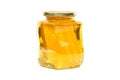 Glass jar filled with honey and honeycomb isolated on white Royalty Free Stock Photo