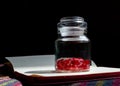 A glass jar filled with red 4-sided dice Royalty Free Stock Photo