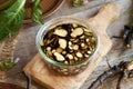 Glass jar filled with sliced comfrey root and alcohol - prepration of tincture Royalty Free Stock Photo