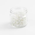 Glass Jar Filled with White Candy Grains Against a White Background in Studio Lighting Royalty Free Stock Photo