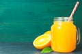 Glass jar of fresh orange juice with fresh fruits on dark table Royalty Free Stock Photo