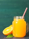 Glass jar of fresh orange juice with fresh fruits on dark table Royalty Free Stock Photo