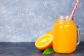 Glass jar of fresh orange juice with fresh fruits on dark table Royalty Free Stock Photo