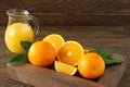 Glass jar of fresh orange juice with fresh fruits on dark wooden table Royalty Free Stock Photo