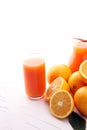 Glass jar of fresh orange juice with fresh fruits on white table Royalty Free Stock Photo