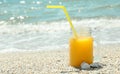 Glass jar of fresh orange juice on seaside, space for text. Summer vacation Royalty Free Stock Photo