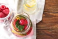 Glass jar of fresh raspberry mojito on wooden table Royalty Free Stock Photo