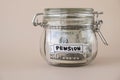 Glass jar full of American currency dollars cash banknote with text PENSION. Preparation saving money. Moderate Royalty Free Stock Photo