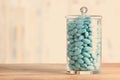 Glass jar full of blue sugared almonds whit tone color in insta