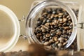 A glass jar full of coffee beans overturned on a table Royalty Free Stock Photo