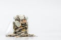 Glass jar full of coins, with copy space on white background Royalty Free Stock Photo