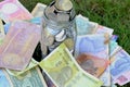 glass jar full of coins on different currency note Royalty Free Stock Photo