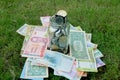 Glass jar full of coins on different currency note Royalty Free Stock Photo