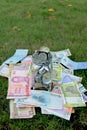 glass jar full of coins on different currency note Royalty Free Stock Photo