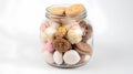 Glass jar full of different cookies isolated on white background with clipping path