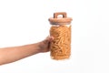 Glass jar full of dry italian penne pasta over isolated background Royalty Free Stock Photo