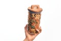 Glass jar full of dry italian vegetables pasta over isolated background Royalty Free Stock Photo