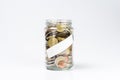 Glass jar full of euro coins with blank white label Royalty Free Stock Photo