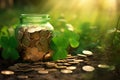 Glass jar full of golden coins amidst green sprouts and illuminated background Royalty Free Stock Photo
