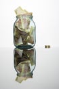 Glass jar full of hundreds of grivnas Royalty Free Stock Photo