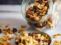 A Glass Jar Full of Nuts, Seeds and Dried Fruits Spilling Out Onto the Lid and the Wooden Counter, Healthy Carbs and Good Fats! Royalty Free Stock Photo