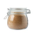 Glass jar of granulated brown sugar isolated on white