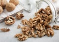 Glass jar with healthy raw walnut whole and peeled nuts on white kitchen table.Macro Royalty Free Stock Photo