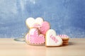 Glass jar and heart shaped cookies on wooden table. Royalty Free Stock Photo