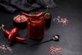 Glass jar with homemade classic spicy tomato pasta or pizza sauce with spices and herbs Royalty Free Stock Photo