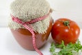 Glass jar of homemade ketchup and a tomato Royalty Free Stock Photo
