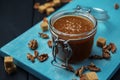 A glass jar of homemade salted caramel and fried walnuts with pieces of cane sugar Royalty Free Stock Photo