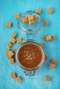 A glass jar of homemade salted caramel with pieces of cane sugar Royalty Free Stock Photo