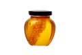 glass jar of honey with honeycomb inside on white background Royalty Free Stock Photo