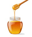 Glass jar of honey with wooden spoon