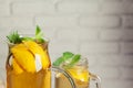 Glass jar of Ice green tea with lime, lemon, mint on wooden table. Royalty Free Stock Photo