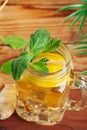 Glass jar of Ice green tea with lime, lemon, mint on wooden table. creative photo. Royalty Free Stock Photo