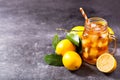 Glass jar of iced tea with fresh lemons Royalty Free Stock Photo