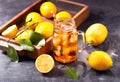 Glass jar of iced tea with fresh lemons Royalty Free Stock Photo