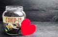 Glass jar with the inscription Covid-19 and a heart. Coronavirus pandemic infection. Healthcare, medicine concept. Ambulance. Royalty Free Stock Photo