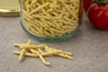 Glass jar with Italian trofie pasta close up