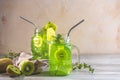 Glass jar of kiwi juice or smoothie. Kiwi Mojito cocktail or non-alcohol mocktail with mint and sliced kiwi fruits on wooden Royalty Free Stock Photo